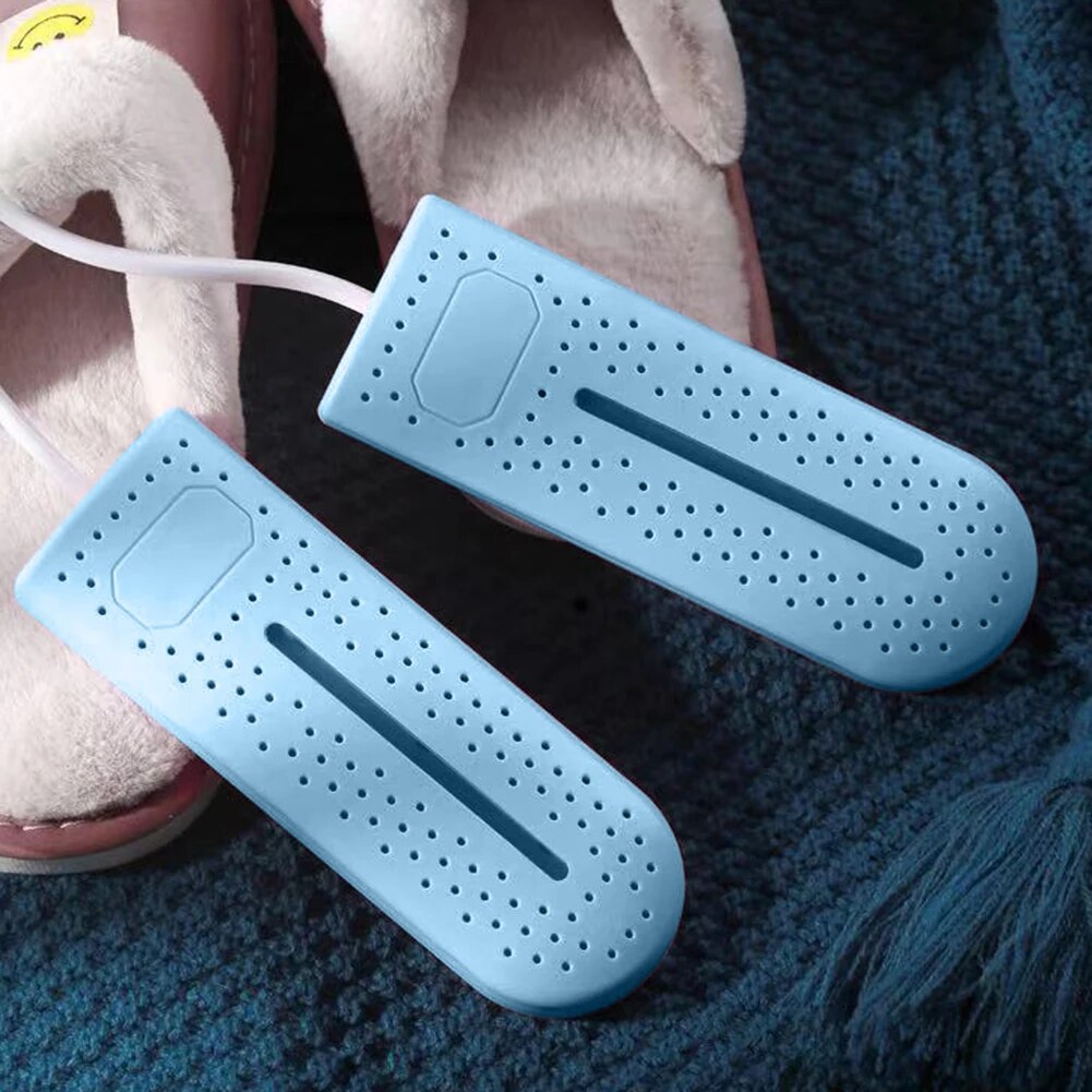 Light blue shoe dryers resting in open shoes on floor, showing central purple bar.