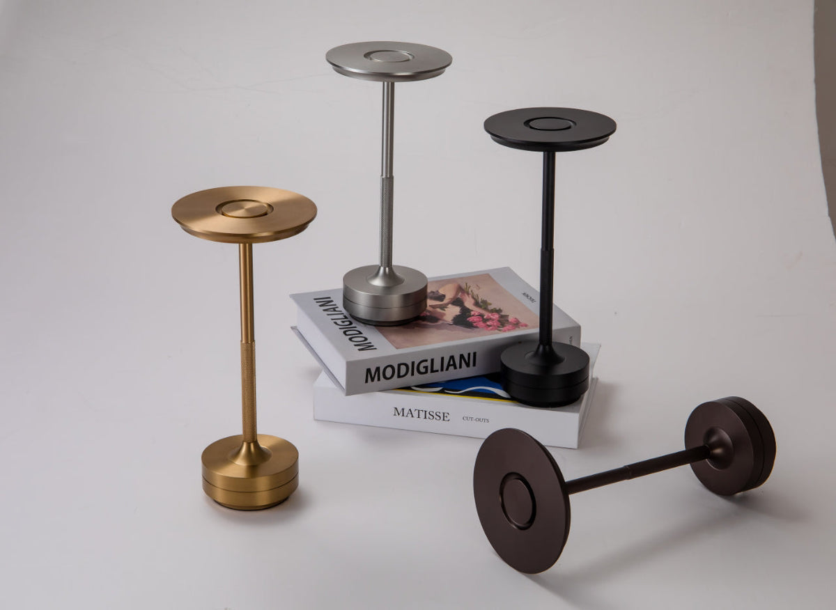 Rechargeable table lamp set with round LED heads in black, bronze, and gold
