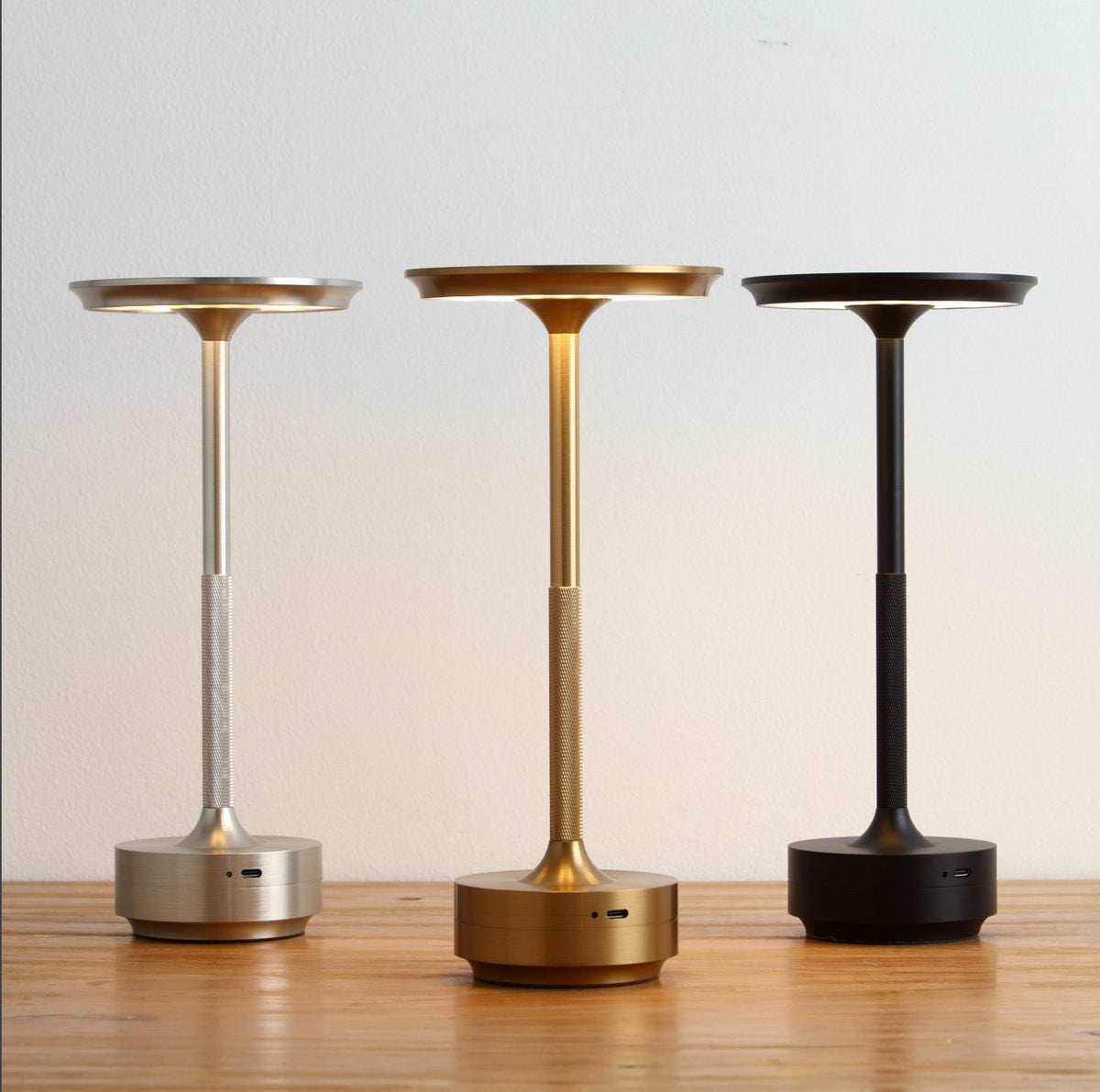 Cordless LED table lamps with dark base, bronze stem, and round top shade