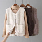Beige sleeveless knit sweater vest layered over ribbed long-sleeve top set