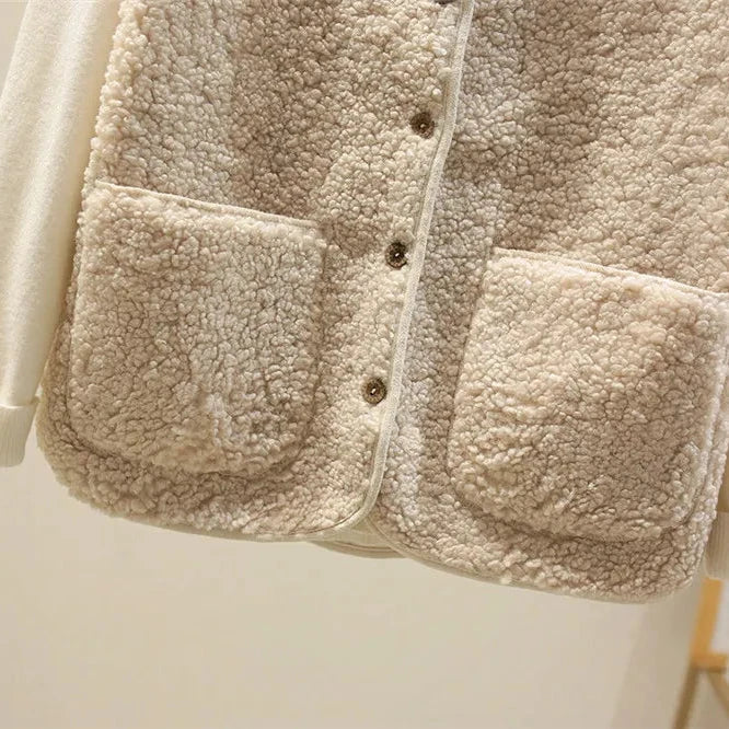 Cream textured sleeveless knit vest with button placket and two patch pockets