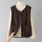 Dark brown sleeveless knit sweater vest over cream ribbed long-sleeve top set