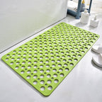 Green non-slip shower mat with circular drainage holes for safer wet floors.