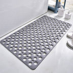 Gray perforated shower mat with non-slip backing for bathtub or shower floor.
