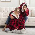 Red and black plaid oversized wearable blanket hoodie with hood and sherpa lining.