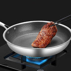 Non-stick stainless steel frying pan with honeycomb textured interior and side handles