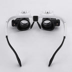 LED head magnifier glasses with white headband and two black lens units