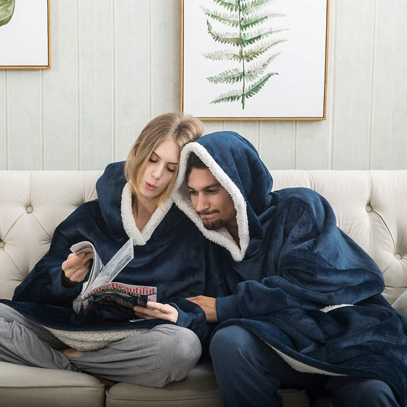 Navy oversized wearable blanket hoodie with hood and sherpa lining for extra warmth.