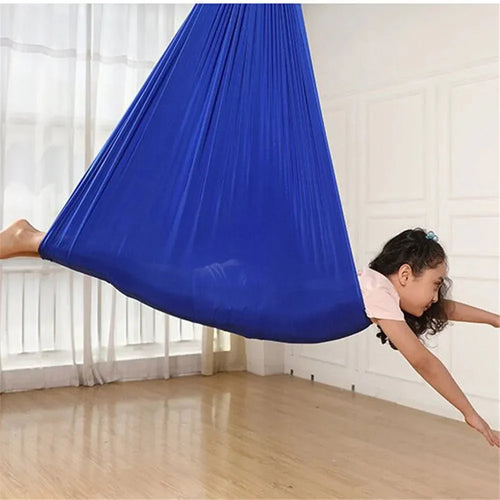 Blue kids' cotton hammock swing cocoon suspended, child leaning out with arms extended.