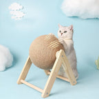 Cat using sisal scratching sphere on wooden tripod stand