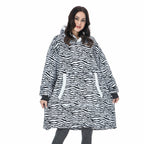 Zebra-print oversized wearable blanket hoodie with hood and front kangaroo pocket.