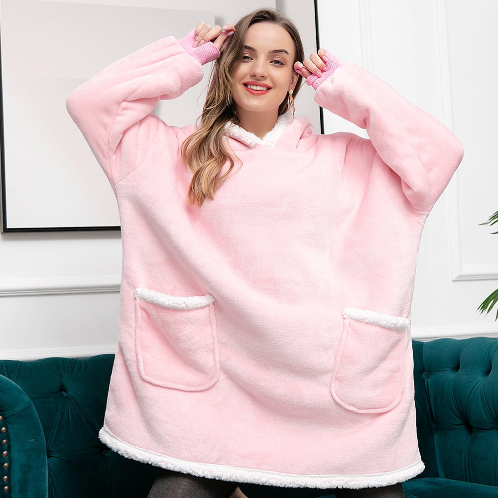 Oversized blush pink fleece wearable blanket hoodie with hood and kangaroo pocket, sherpa trim.