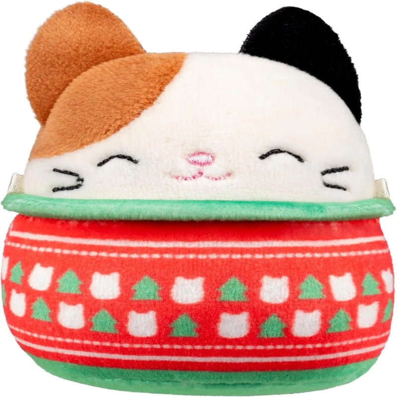 Mini marshmallow-style plush collectible figure in red and green festive sweater