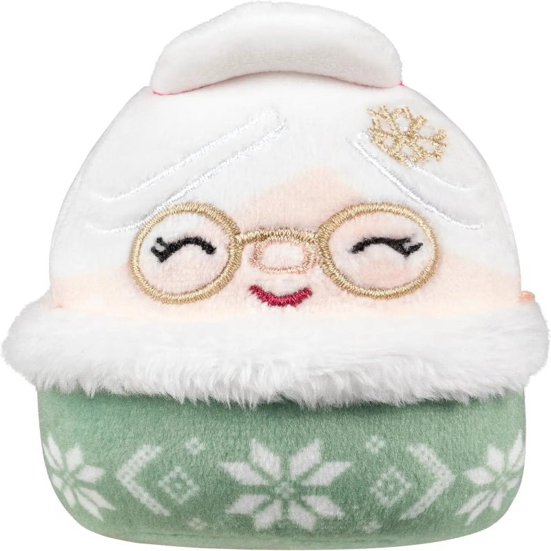 Mini marshmallow-style plush collectible figure with white hood, gold glasses, and green sweater