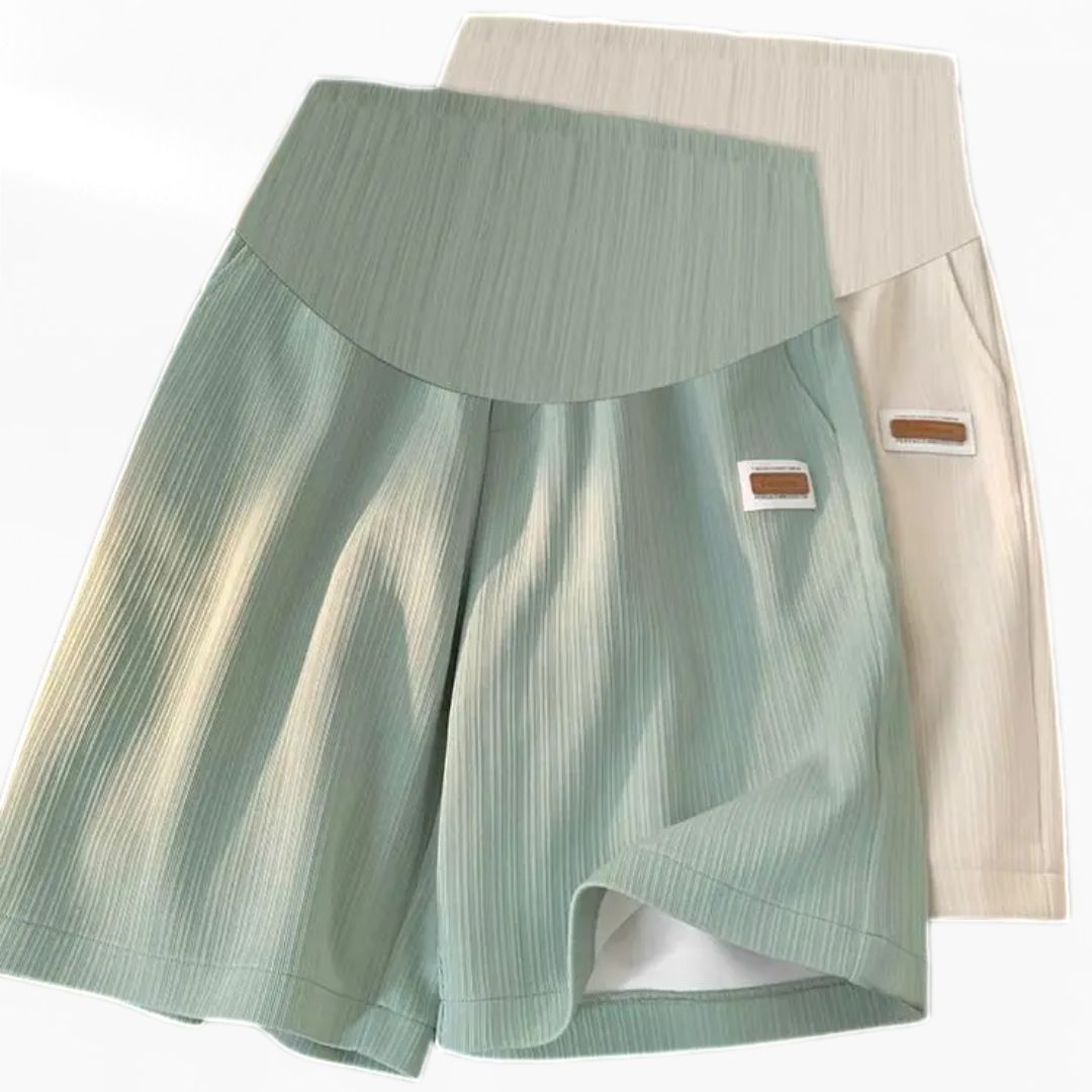 Seamless high-waist maternity bike shorts in light green, with beige waistband