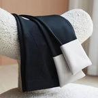 Black maternity leggings with ribbed front panel and smooth waistband, folded