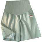 Seamless high-waist maternity bike shorts in light green, with gusseted front