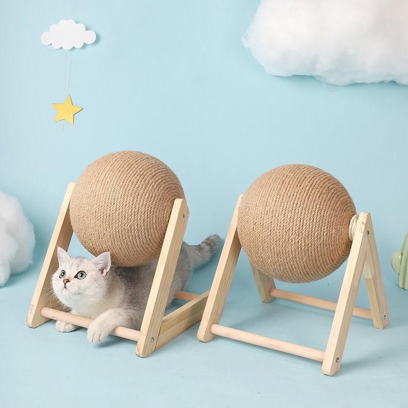 Cat scratching toy with two tan sisal balls on wooden frames, with cats exploring.