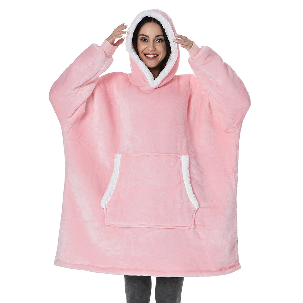 Blush pink oversized wearable blanket hoodie with hood and front kangaroo pocket.