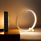 Minimalist round LED table lamp with touch control, glowing halo ring, dark knob base