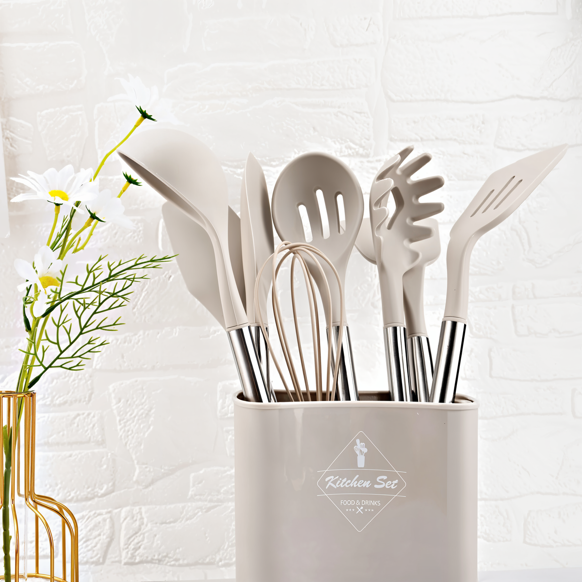 White silicone cooking utensil set standing in a matching holder with stainless handles