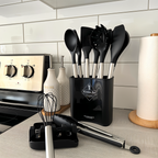 Black silicone kitchen utensil set in a black holder with stainless steel handles