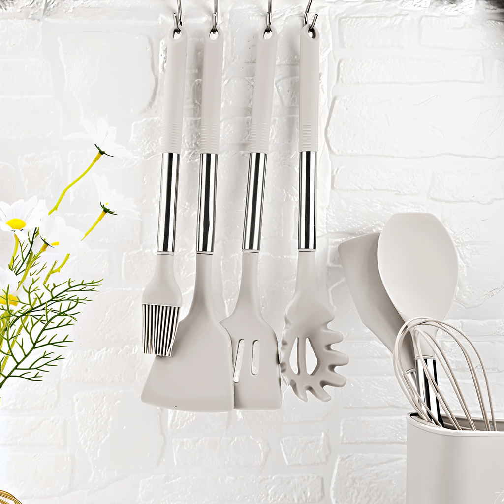 White silicone kitchen utensil tools hanging from hooks with stainless steel handles