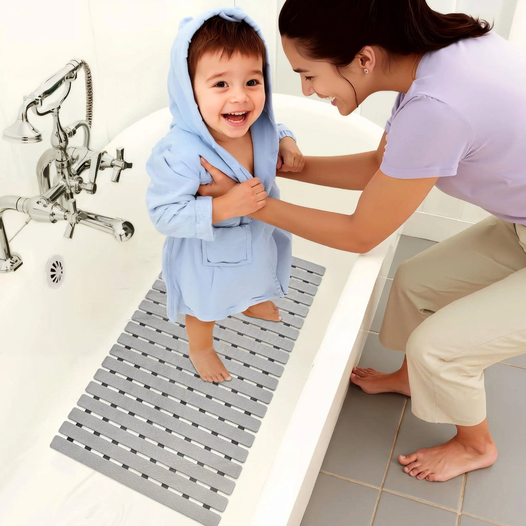 Gray non-slip bath mat with ridged surface and drainage holes, rectangular for shower use
