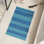 Blue non-slip bath mat with ridged drainage holes and suction cups, rectangular 16x25 in