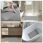 Gray non-slip bath mat with drainage holes, textured grip strips, suction-cup backing