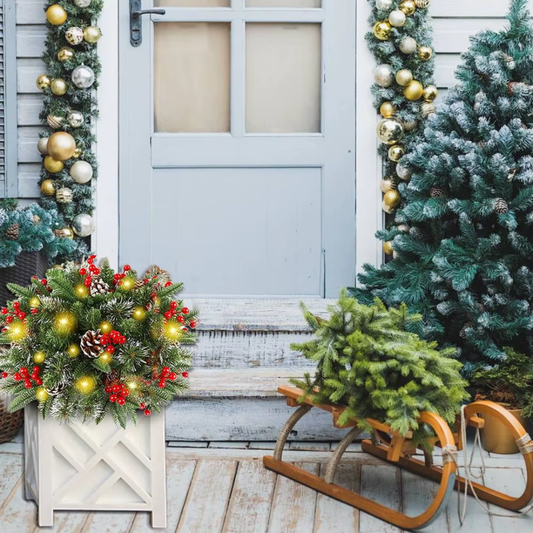 Lighted pine wreath planter insert with red berries and warm yellow LEDs on a planter stand