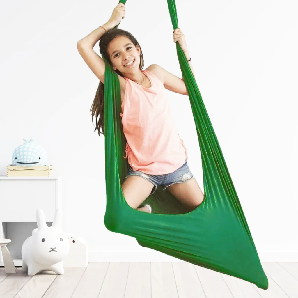 Green kids' cotton hammock swing cocoon, child sitting inside and holding the strap.