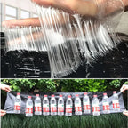 Black sticky glue trap mats displayed in a long row, hands holding the set