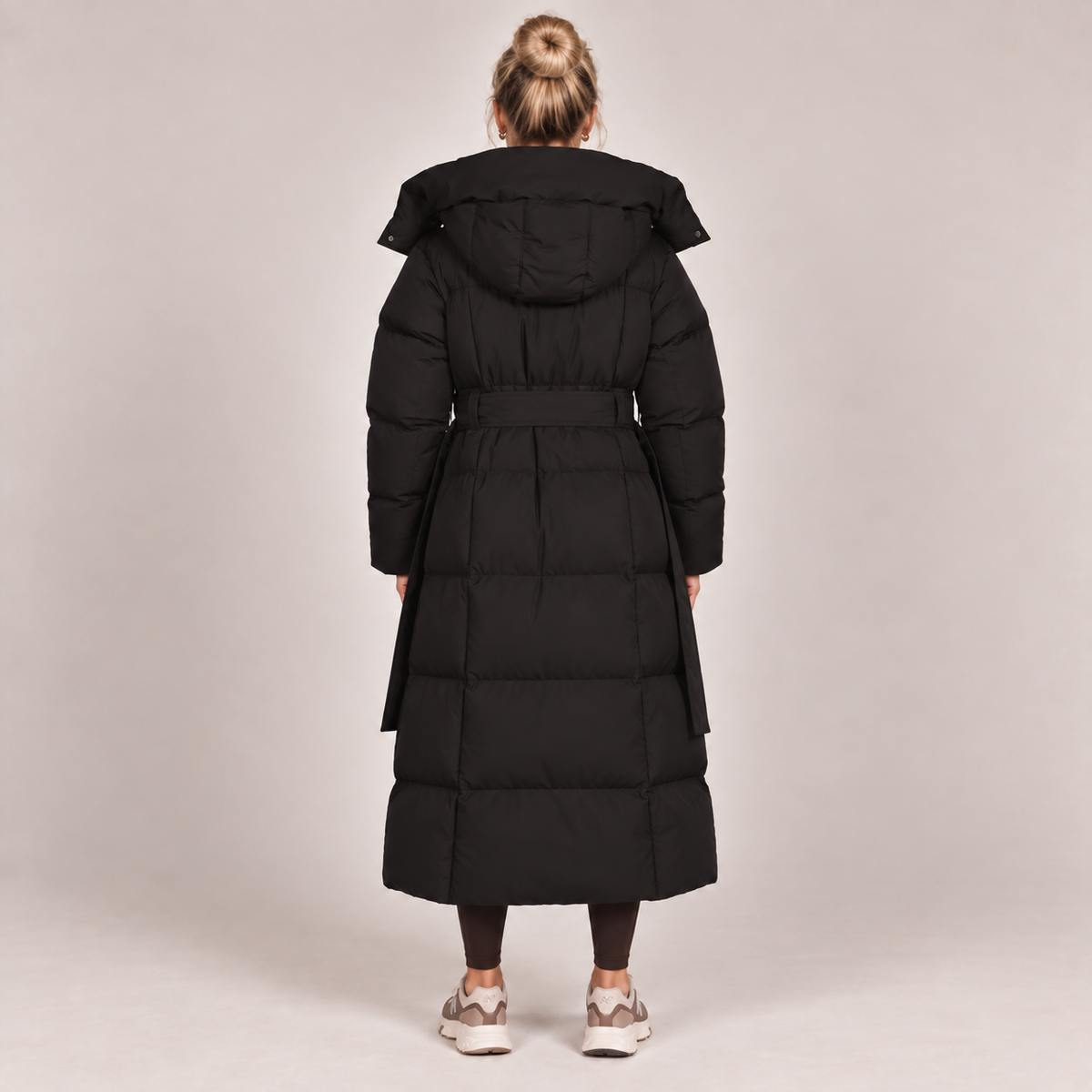 Long hooded puffer coat, black, belted waist, padded back view with hood