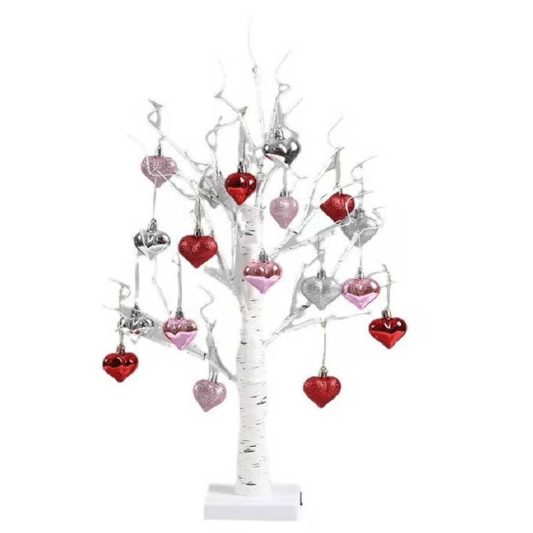 White birch tree decoration with silver, red, and pink heart ornaments