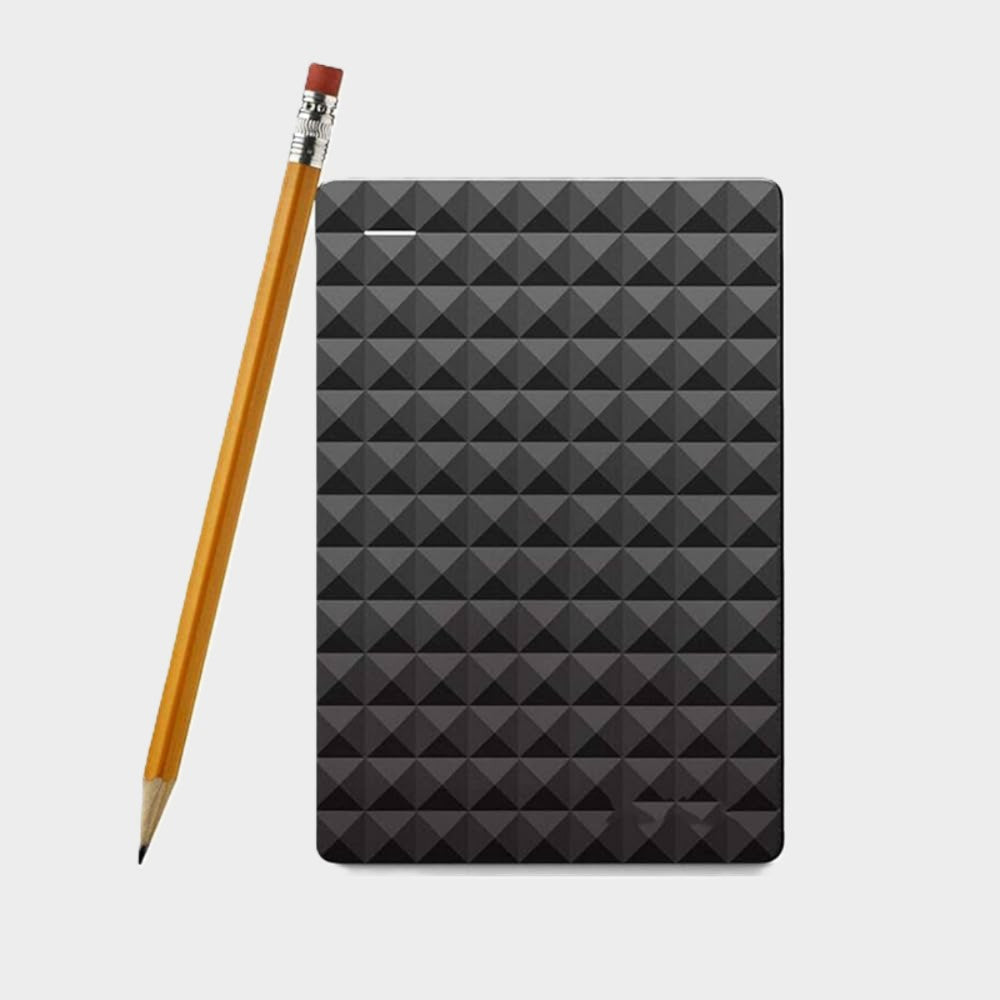 Black external hard drive with geometric pattern beside pencil for size comparison