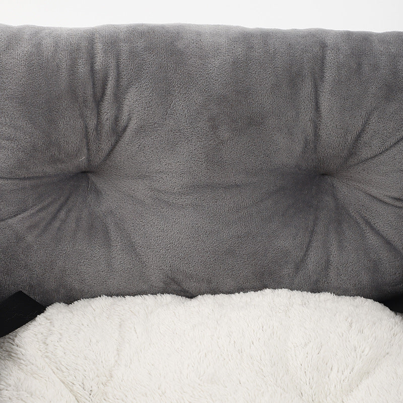 Gray booster bed cushion with tufted bolsters and fluffy white inner lining