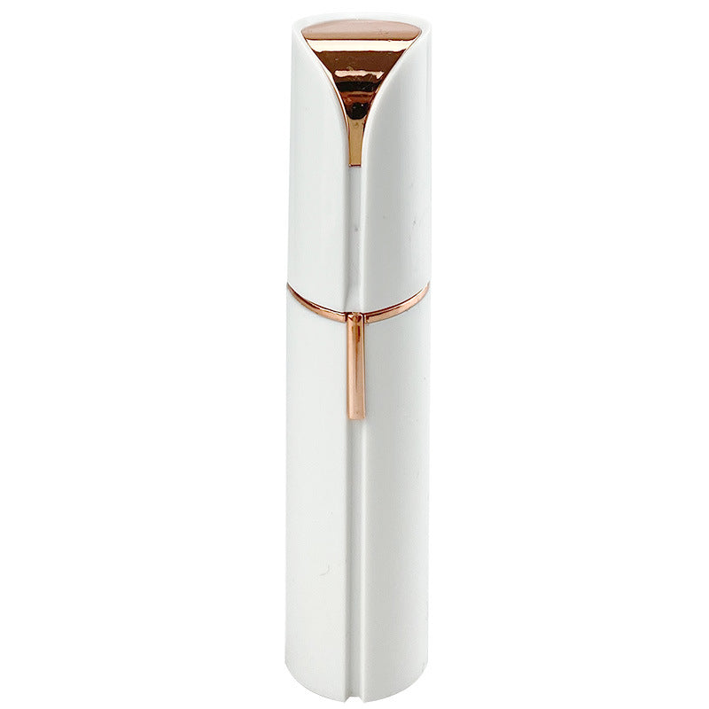 White facial hair remover with gold-tone top and compact grooming head