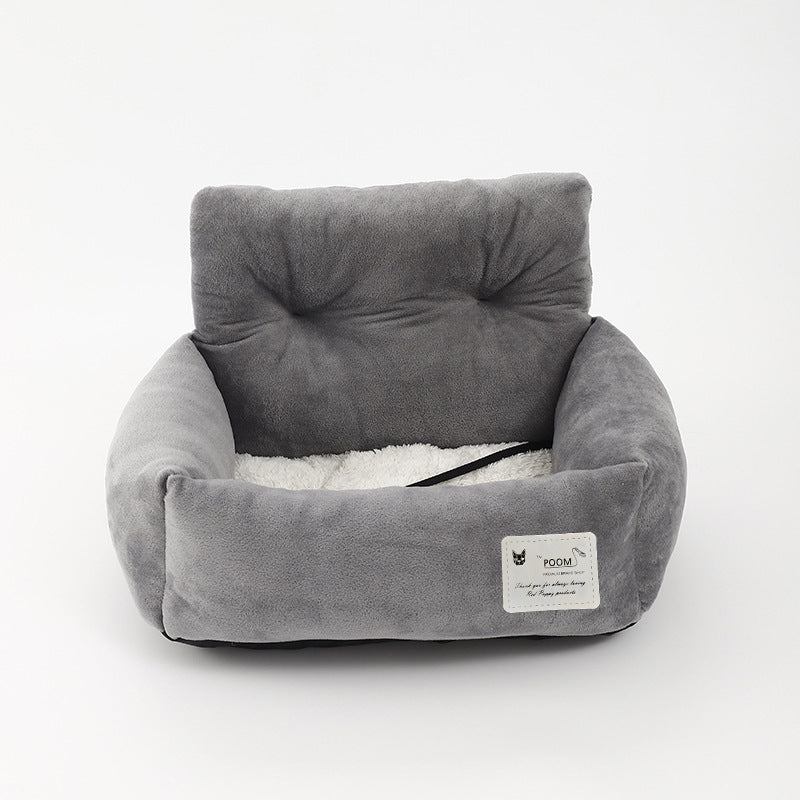 Gray soft-lined dog booster bed with raised bolster and black safety strap