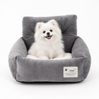 Gray soft dog booster bed with plush lining and small white dog sitting inside