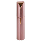 Rose gold facial hair remover with built-in grooming head and charging handle