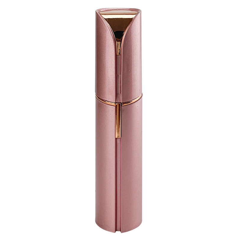 Rose gold facial hair remover with built-in grooming head and charging handle