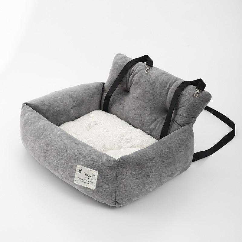 Gray soft dog booster bed with two black straps and square front label