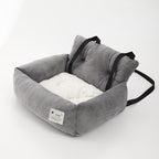 Gray soft dog booster bed with two black straps and square front label