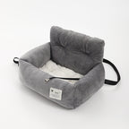 Gray plush dog booster bed with side handle strap and cushioned rim