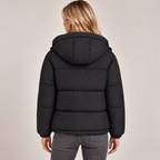 Women's black quilted puffer jacket, back view with hood and zip