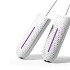 White shoe dryers with purple heating bars, two U-shaped units with cords.