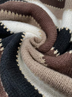 Women’s striped loose sweater in brown, beige, and black knit close-up