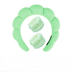 Light green plush spa headband with two matching fuzzy wrist towels for face washing