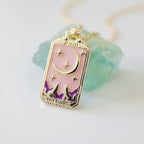 Gold-tone tarot card necklace with purple enamel crescent moon and star motifs, link chain